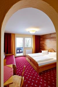 a hotel room with two beds and a window at Hotel Wieser in Mittersill