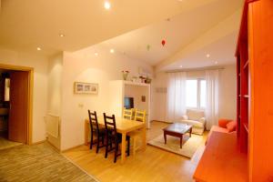 a living room with a table and a dining room at Park View Bucharest in Bucharest