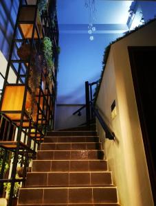 a staircase leading up to a building with plants at Saipan Skyline Designers Hotel in Saipan