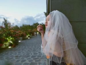 a little girl wearing a wedding veil at Saipan Skyline Designers Hotel in Saipan