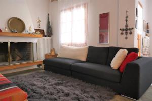 a living room with a black couch and a fireplace at Evergreen Elati in Elati Trikalon +61 photos