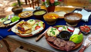 a table with plates of food on a table at Casa 1800 Suchitoto Boutique in Suchitoto