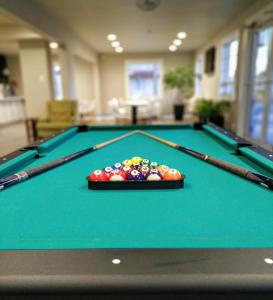 a pool table with a tray of balls on it at Stratus Suites Boutique Hotel in Killeen