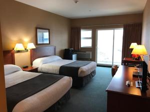 a hotel room with two beds and a window at Beach Gardens Resort and Marina in Powell River