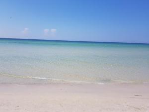 a sandy beach with the ocean in the background at Royal Thalassa Monastir in Monastir