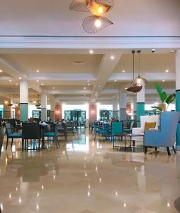 a lobby with chairs and tables in a building at Royal Thalassa Monastir in Monastir