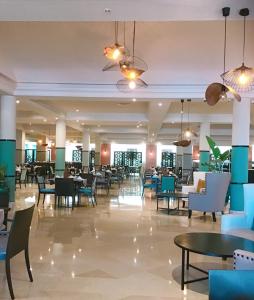 a dining hall with tables and chairs and tablesktop at Royal Thalassa Monastir in Monastir