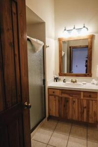 a bathroom with a sink and a mirror at Taharaa Mountain Lodge in Estes Park