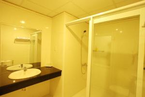 a bathroom with a sink and a glass shower at Hai Yen Family Hotel in Mui Ne