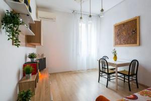 a living room with a table and chairs and a tv at Elly's House in Modena