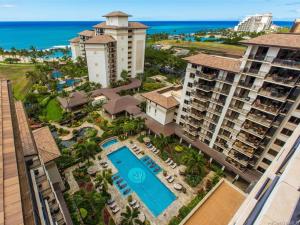 an aerial view of a resort with a pool and the ocean at Luxurious Ocean View Beach Villa B-903 at Ko'Olina Beach Villas in Kapolei