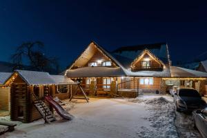 a log cabin in the snow at night at Sadyba Pikuy in Belasovitsa +235 photos