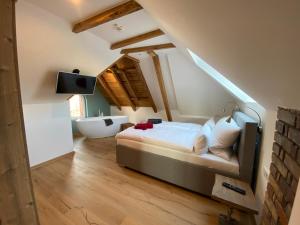 a bedroom with a bed and a bathroom with a sink at Braunlage Lodge in Braunlage