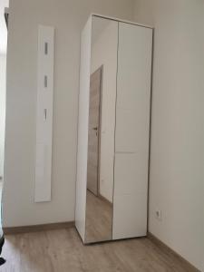 a large white closet with a mirror in a room at Pension Stamperl Bar in Vohburg an der Donau