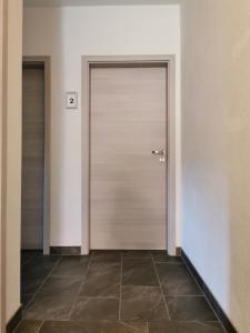 a hallway with two doors and a tile floor at Pension Stamperl Bar in Vohburg an der Donau