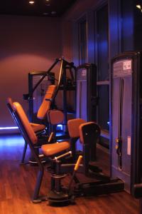 a gym with orange chairs in a room at Royal Thalassa Monastir in Monastir