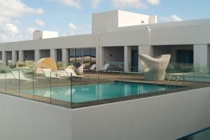 a swimming pool on the roof of a building at Royal Thalassa Monastir in Monastir
