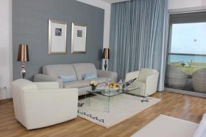 a living room with a couch and a table at Royal Thalassa Monastir in Monastir