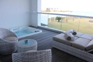 a living room with a couch and a hot tub at Royal Thalassa Monastir in Monastir