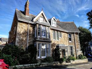 a brick house with a chimney on a street at Treventon Guest House in Penzance