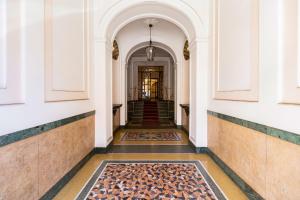 a hallway of a building with a rug on the floor at Silver Suite Coliseum in Rome