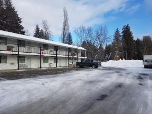 a car parked on the side of a road at Anchor Riverfront Motel in Sicamous