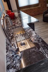 a granite counter top with a sink in a kitchen at 48 King West in Brockville