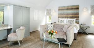 a bedroom with a bed and a table and a chair at Kentisbury Grange in Kentisbury