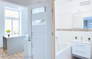 a bathroom with a sink, toilet, and bathtub at Apartament na Granicy / Apartment on the border in Cieszyn