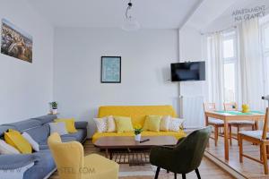 a living room filled with furniture and a tv at Apartament na Granicy / Apartment on the border in Cieszyn