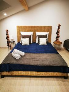 1 dormitorio con 1 cama grande con sábanas y almohadas azules en VILLA VACANCES NEUVE en Bompas