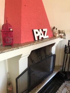 a red and white fireplace with a tv on it at Pousada da Paz in Curitiba