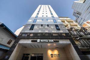 a hotel building with a sign on the front of it at Hotel DDK in Seoul