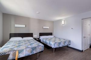 a room with two beds and a door at Motel 6-Show Low, AZ in Show Low