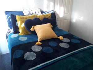 a blue bed with two teddy bears laying on it at Blue House in Ensenada