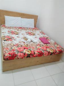 a bedroom with a bed with flowers on it at Lapyahan Guest House in Siquijor