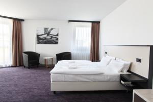 Postel nebo postele na pokoji v ubytování Dietrich-Bonhoeffer-Hotel Berlin Mitte