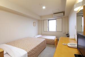 Postel nebo postele na pokoji v ubytování Best Inn Uozu + 37 fotografií