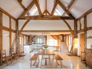 a kitchen and dining room with wooden beams at Ty Camlad in Hyssington