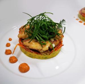 a white plate with a sandwich with greens on it at Drake Bay Greenleaf in Drake