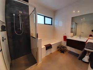 a bathroom with a shower and a sink at Spring Beach Garden Retreat in Spring Beach