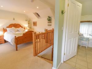 a bedroom with a large bed and a staircase at Happy Landing in Harlech