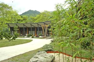 uma casa no meio de um jardim em Butterfly Valley Resort em Ruisui