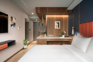 Voodi või voodid majutusasutuse Kindness Day Hotel toas