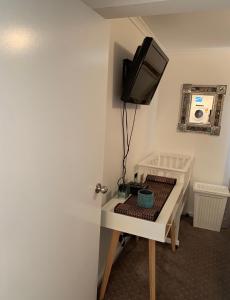 a room with a television and a table with a tv at Relax On Bingham in Goolwa