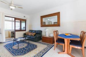 uma sala de estar com uma mesa e um sofá em B9 Crawley Apartment 1 BRM & Sleepout near UWA em Perth