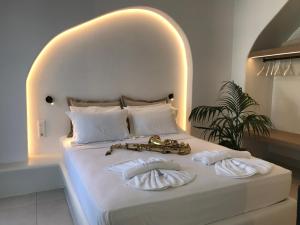 a bedroom with a bed with a saxophone on it at Quartano Luxury Cycladic Residence, Adults Only (13+) in Naousa
