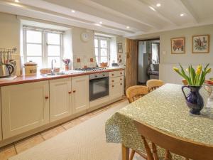 a kitchen with a table and a counter top at Haulfryn in Llangynog