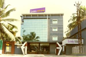 a building with a sign on top of it at Luxora Hotel and Spa in Kozhikode