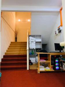 a room with a staircase and a stair case at Suza Hostel in Tumpat